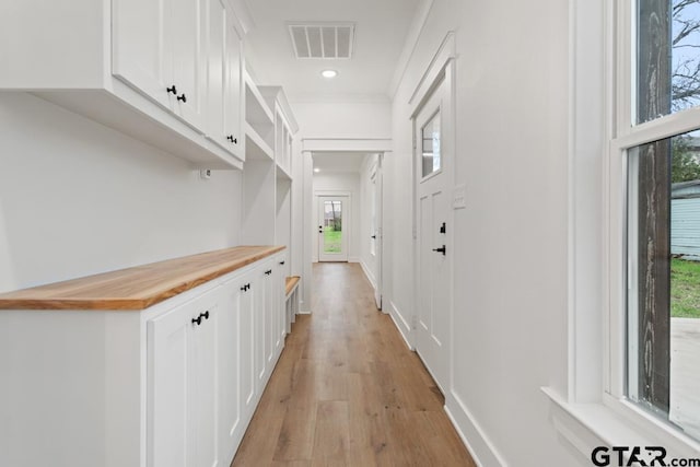 hallway with light hardwood / wood-style flooring