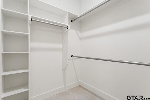 spacious closet with light tile patterned floors