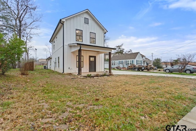 modern farmhouse featuring a porch and a front lawn