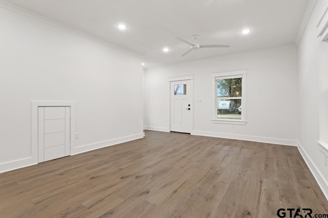 unfurnished room with ceiling fan, ornamental molding, and light hardwood / wood-style flooring