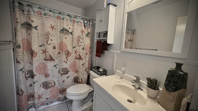 bathroom featuring tile patterned flooring, a shower with shower curtain, a textured ceiling, vanity, and toilet