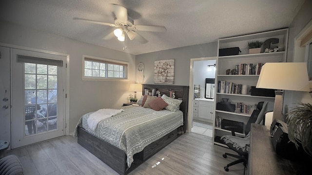 bedroom with connected bathroom, a textured ceiling, ceiling fan, and light hardwood / wood-style flooring