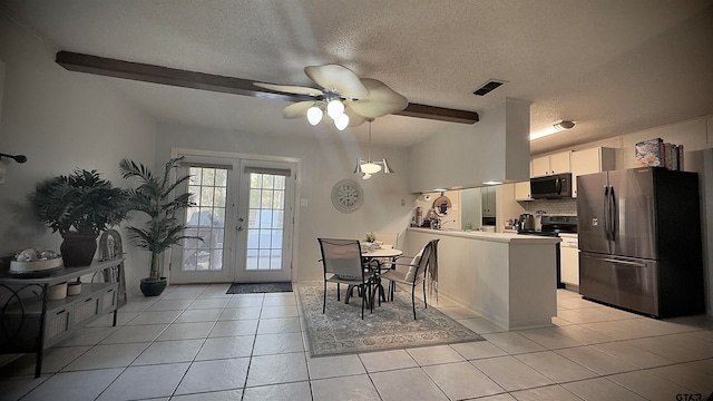 tiled dining room featuring a textured ceiling, vaulted ceiling with beams, and ceiling fan