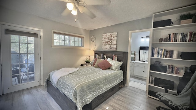 bedroom featuring ceiling fan, connected bathroom, access to exterior, and light hardwood / wood-style flooring