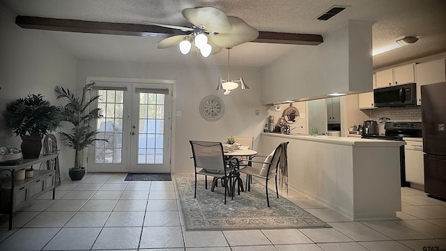 tiled dining space featuring ceiling fan, beamed ceiling, and a textured ceiling