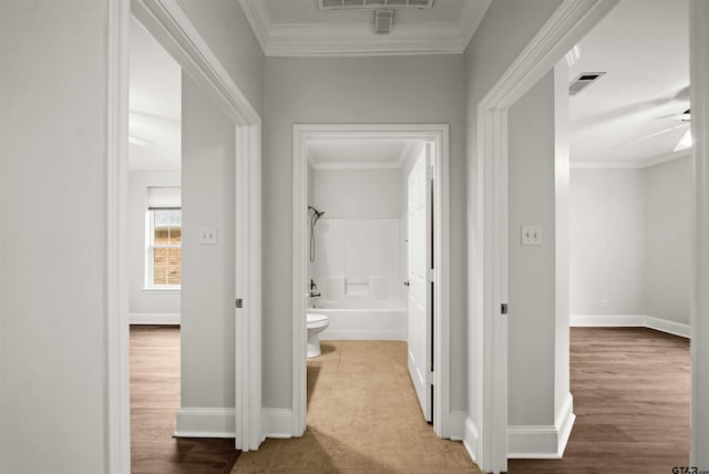 hallway featuring light hardwood / wood-style floors and ornamental molding