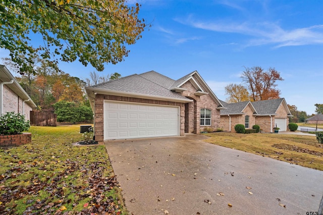 view of front of property featuring a front lawn and a garage