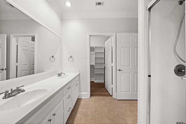 bathroom with tile patterned floors, vanity, and ornamental molding