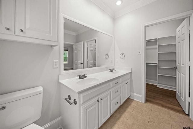 bathroom featuring crown molding, hardwood / wood-style floors, vanity, and toilet