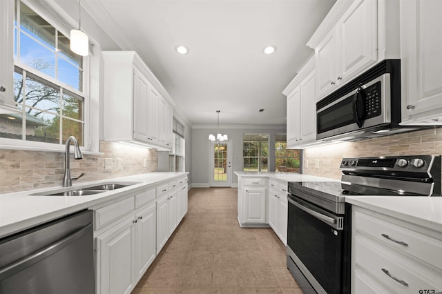 kitchen featuring pendant lighting, stainless steel appliances, white cabinetry, and sink