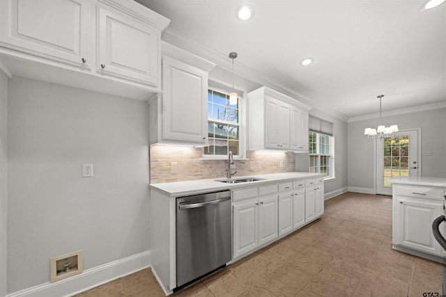 kitchen featuring stainless steel dishwasher, sink, pendant lighting, an inviting chandelier, and white cabinetry