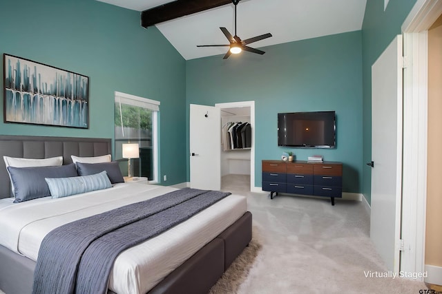 bedroom with carpet flooring, ceiling fan, beam ceiling, high vaulted ceiling, and a walk in closet