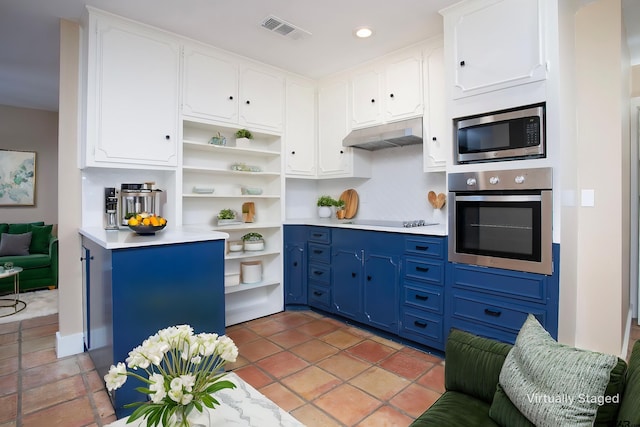 kitchen with under cabinet range hood, stainless steel appliances, open shelves, blue cabinetry, and white cabinets