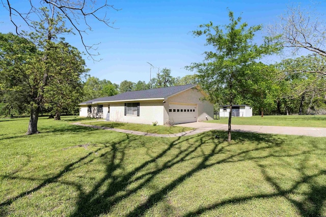 view of side of home featuring a yard, concrete driveway, and a garage