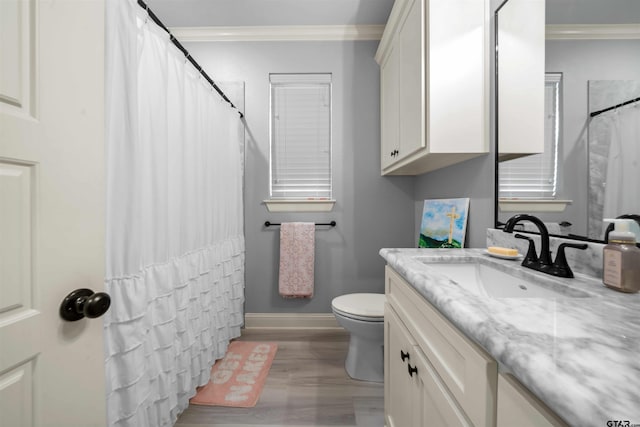 bathroom with hardwood / wood-style flooring, vanity, toilet, and crown molding