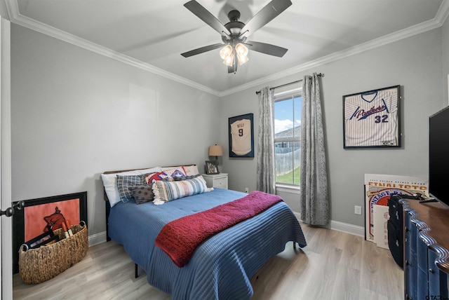 bedroom featuring ornamental molding, light wood-type flooring, and ceiling fan