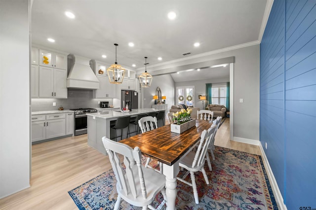 dining room featuring light hardwood / wood-style floors and ornamental molding