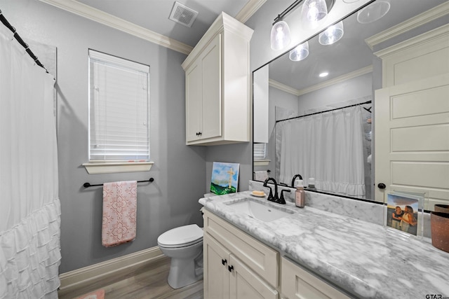 bathroom featuring ornamental molding, wood-type flooring, toilet, and vanity