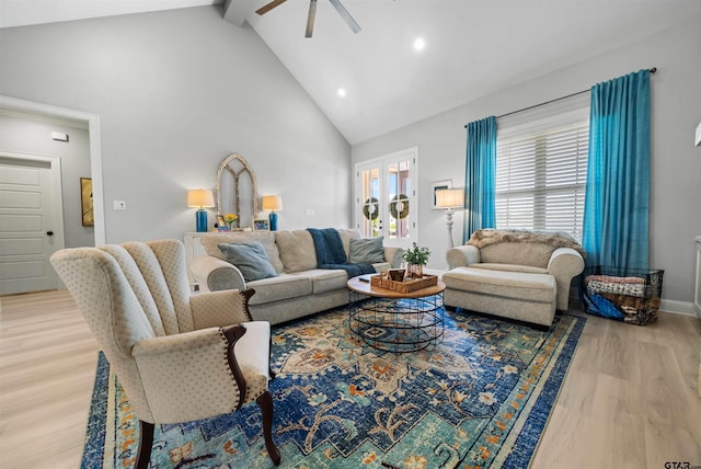 living room with ceiling fan, wood-type flooring, beamed ceiling, and high vaulted ceiling