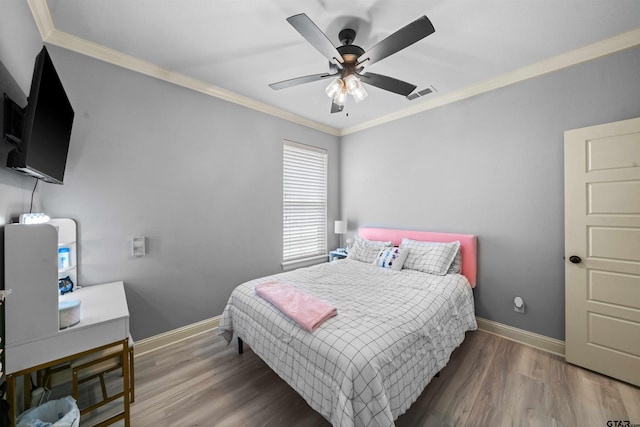 bedroom with ceiling fan, crown molding, and wood-type flooring