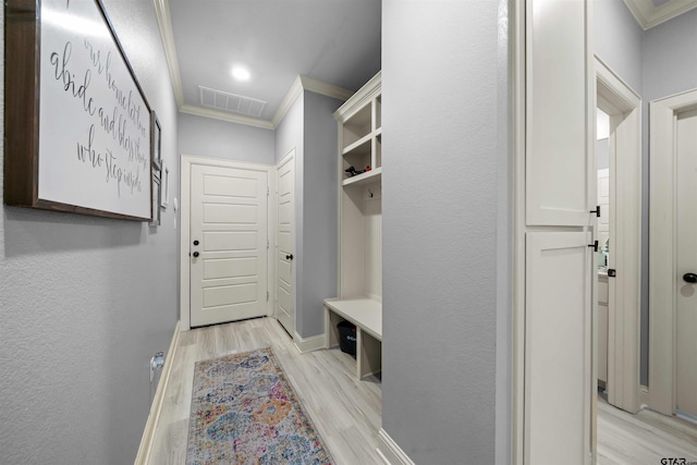 mudroom featuring light wood-type flooring and crown molding