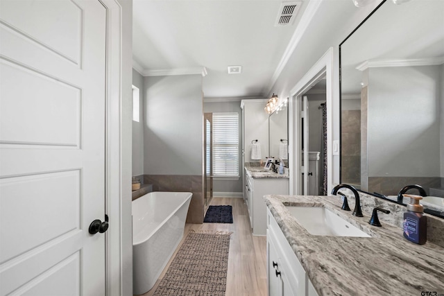 bathroom featuring vanity, wood-type flooring, ornamental molding, and separate shower and tub