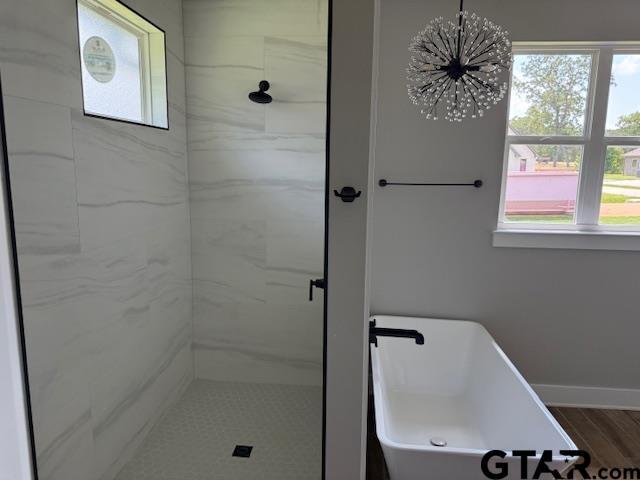 14533 Woodland Creek Dr, Tyler, TX 75706 - full bath featuring a stall shower and a chandelier