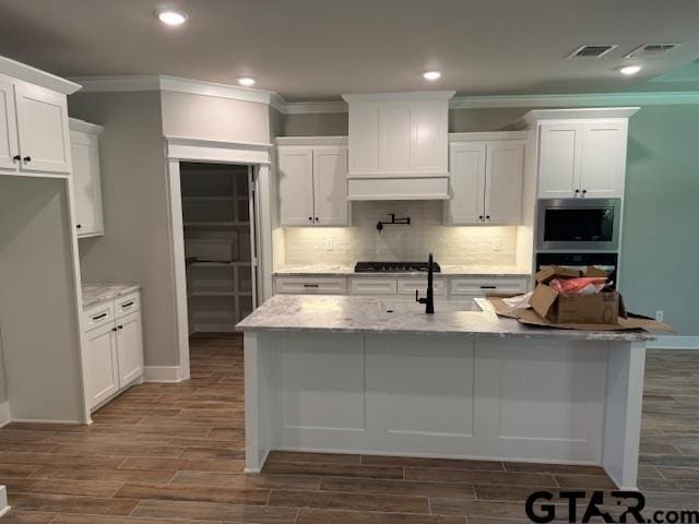 14533 Woodland Creek Dr, Tyler, TX 75706 - kitchen with appliances with stainless steel finishes, ornamental molding, dark wood-type flooring, white cabinetry, and recessed lighting