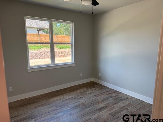 14533 Woodland Creek Dr, Tyler, TX 75706 - spare room featuring a ceiling fan and dark wood-type flooring