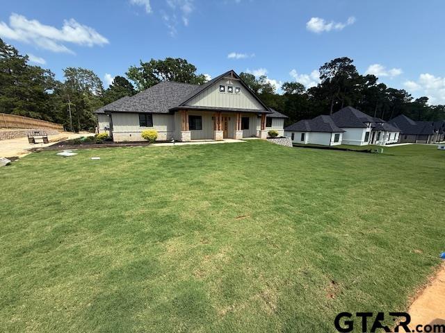 14533 Woodland Creek Dr, Tyler, TX 75706 - view of front of house featuring a front lawn and a porch