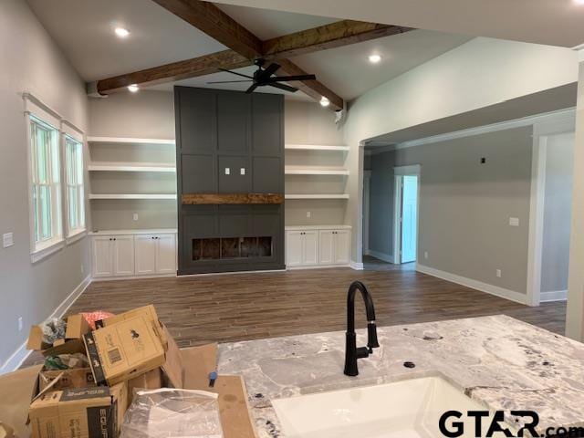 14533 Woodland Creek Dr, Tyler, TX 75706 - unfurnished living room featuring wood finished floors, beam ceiling, a fireplace, a ceiling fan, and recessed lighting