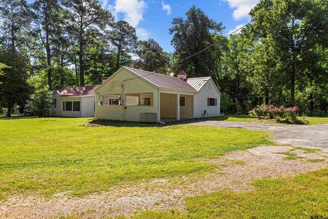 552 W State Highway 7, Crockett, TX 75835 - view of front of home featuring a front lawn and metal roof