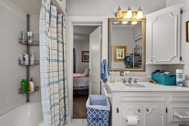 552 W State Highway 7, Crockett, TX 75835 - ensuite bathroom featuring vanity, shower / tub combo with curtain, and tile patterned flooring