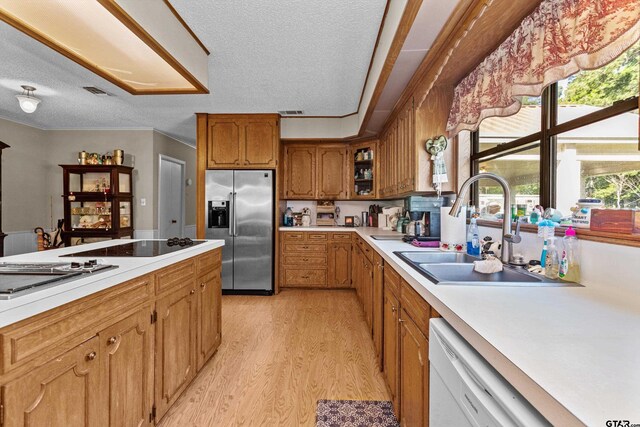 552 W State Highway 7, Crockett, TX 75835 - kitchen featuring stainless steel refrigerator with ice dispenser, a sink, light wood-style floors, dishwasher, and brown cabinetry