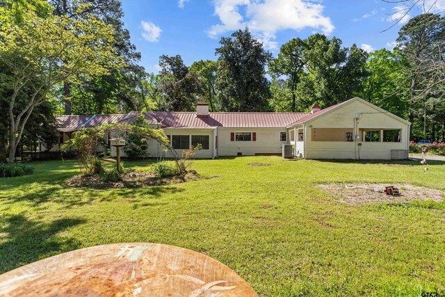552 W State Highway 7, Crockett, TX 75835 - back of house with a chimney, a yard, cooling unit, and metal roof
