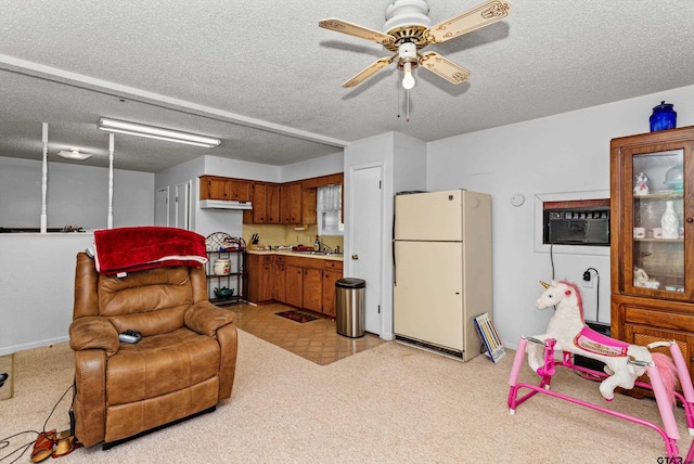 552 W State Highway 7, Crockett, TX 75835 - living area featuring an AC wall unit, a ceiling fan, a textured ceiling, and baseboards