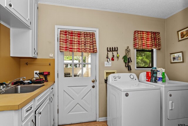552 W State Highway 7, Crockett, TX 75835 - laundry area featuring cabinet space, washer and dryer, and a textured ceiling