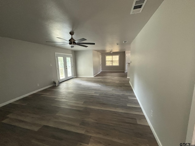 unfurnished living room featuring french doors, dark wood-type flooring, plenty of natural light, and ceiling fan