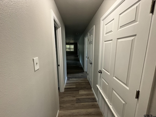 hall with dark hardwood / wood-style floors