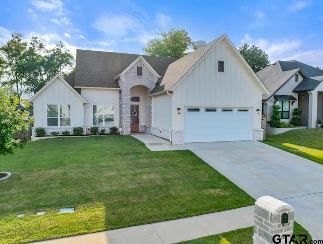 4188 Palo Pinto Creek Cir, Tyler, TX 75703 - view of front of house featuring board and batten siding, a front yard, concrete driveway, and stone siding