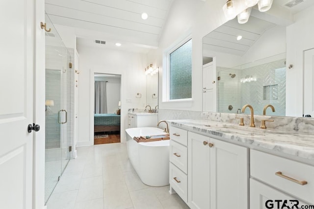 4188 Palo Pinto Creek Cir, Tyler, TX 75703 - full bathroom with vaulted ceiling, a stall shower, two vanities, a soaking tub, and tile patterned floors