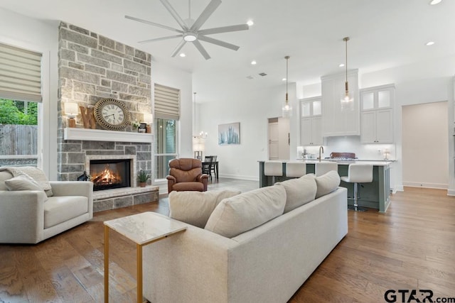 4188 Palo Pinto Creek Cir, Tyler, TX 75703 - living room with a ceiling fan, recessed lighting, wood finished floors, and a stone fireplace