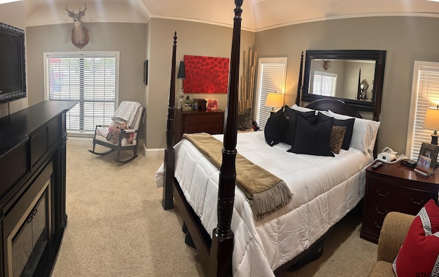 carpeted bedroom featuring lofted ceiling