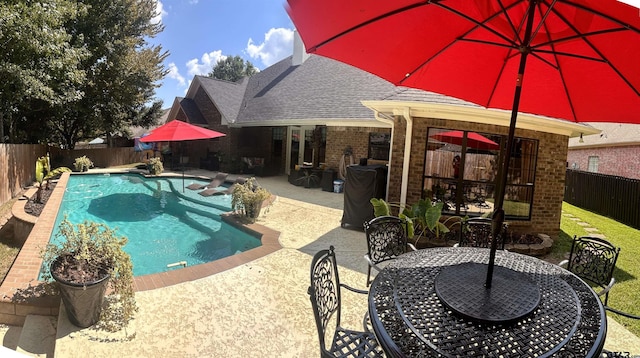 view of swimming pool with a patio area