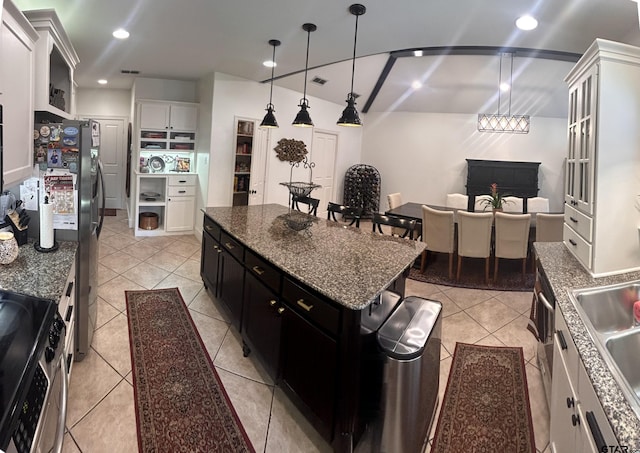 kitchen featuring light tile patterned flooring, pendant lighting, a center island, and white cabinets