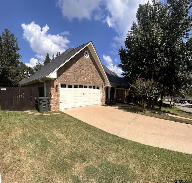 view of front of home with a front lawn and a garage