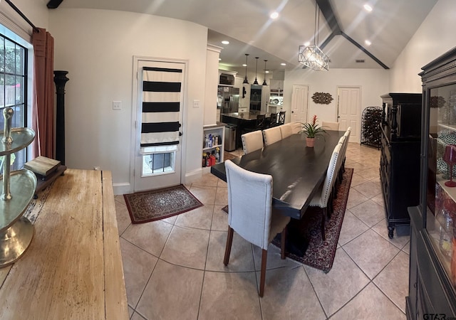 dining area with lofted ceiling and light tile patterned flooring