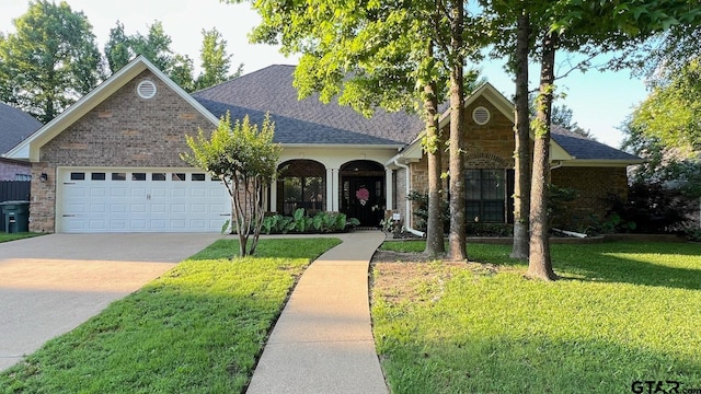 view of front facade featuring an attached garage, a shingled roof, concrete driveway, a front lawn, and brick siding