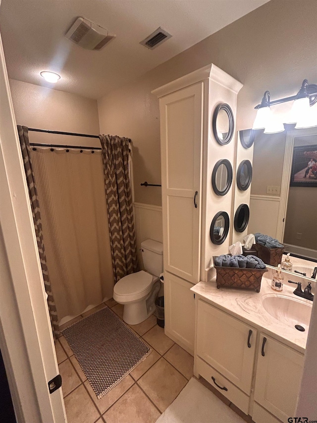 bathroom with toilet, vanity, a shower with shower curtain, and tile patterned flooring