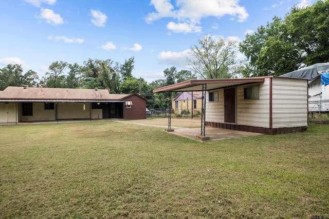 view of yard featuring an attached carport and fence